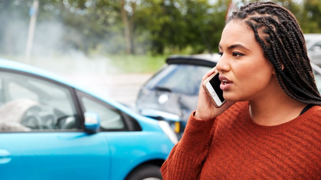 Female calling insurance after accident