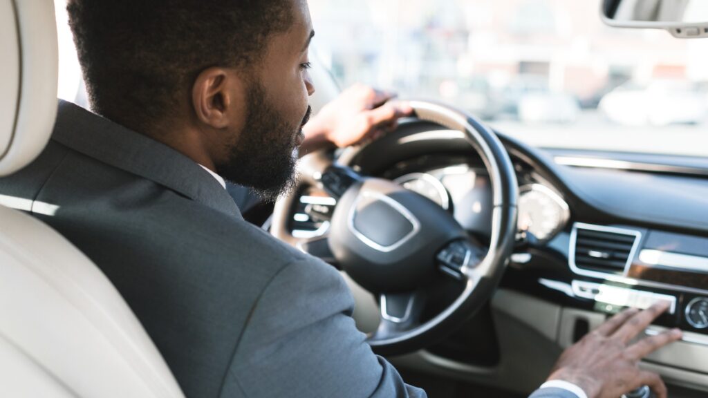 Male in suit driving to work